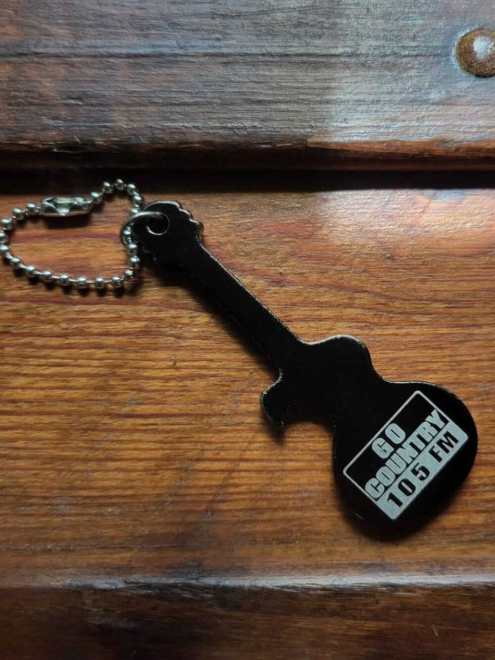 Guitar-Shaped Black Keychain And Promotional Bottle Opener